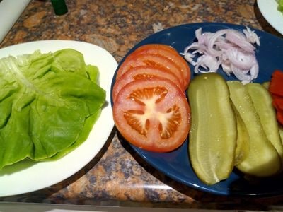 Prepare the ingredients - red onions slices of tomatoes gherkins roasted red pepper and mozzarella Beef & Lettuce Burger