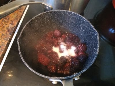 In a sauce pan add the frozen berries and the sweetener Blackberry Jelly Sauce