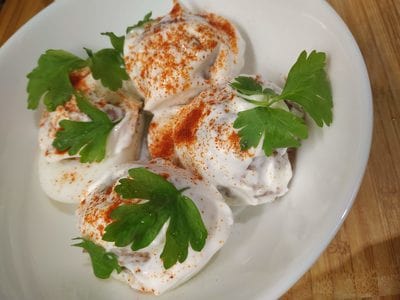 Sprinkle with Paprika and Parsley leaves Devilled Eggs