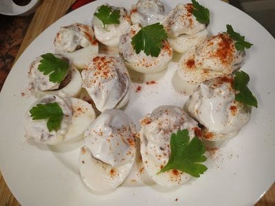 Sprinkle with Paprika and Parsley leaves Devilled Eggs