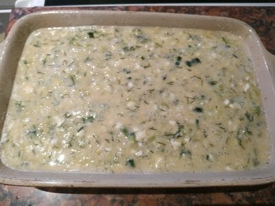 Grease a baking tray with cooking oil and then transfer the mixture Greek Style Courgette Casserole