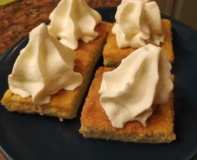 Cut the cake and put cream on top Lemon and Custard Cake