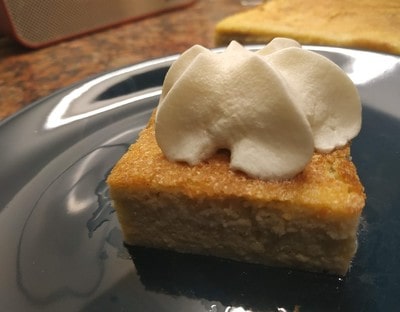 Cut the cake and put cream on top Lemon and Custard Cake