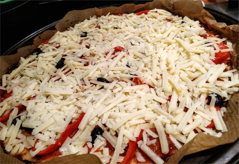 Remove from oven, and then add grated cheese on top Cauliflower Base Pizza