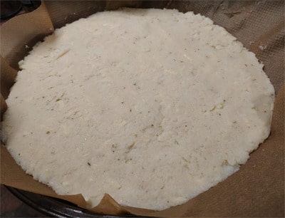 Spread half on a prepared pizza baking tray lined with parchment paper Cauliflower Base Pizza