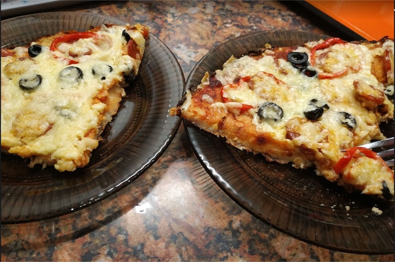 Cut the pizza into quarters Cauliflower Base Pizza