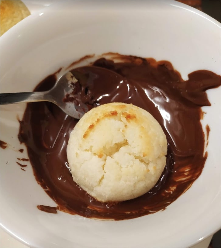 Dip each cooled macaroon in the melted chocolate and place it on parchment paper upside down to allow the chocolate to set Coconut Macaroons