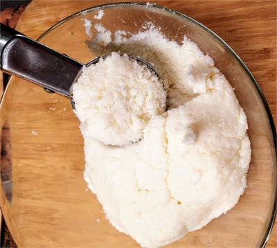Using a large cookie spoon or an ice cream scoop, scoop one full scoop and press the coconut inside the scoop Coconut Macaroons