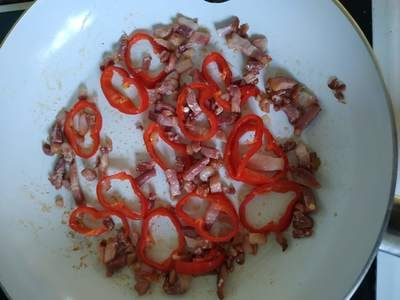 Over the cooked bacon and peppers pour the egg mixture Greek Cheese and Parsley Omelette