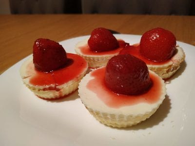 Add the strawberry sauce and strawberries Mini Strawberry Cheese Pies