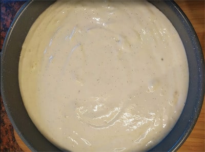 Pour the cheese cream mixture on top of the baked almond base and transfer to the oven New York Strawberry Cheesecake