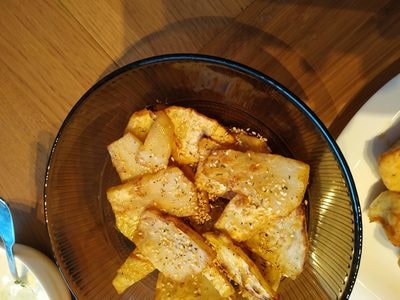 Place wedges on a plate Roasted Celeriac with Soured Cream and Sesame Seeds