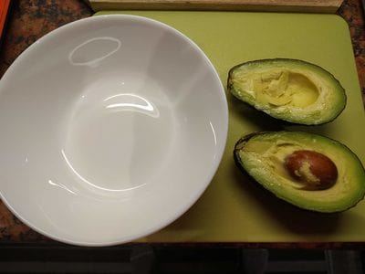 Cut the avocado in half Avocado with Stuffed Tuna