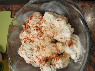 Line another layer of the remaining defrosted cauliflower florets and then sprinkle again with the seasonings Cheesy Roasted Cauliflower