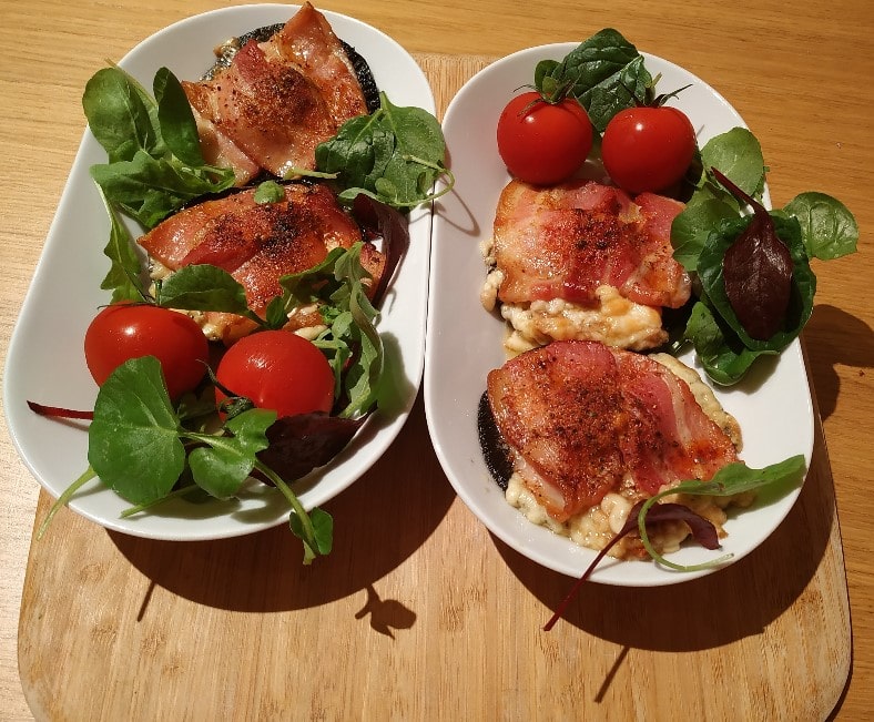 Mushrooms with Cheesy Smoked Streaky Bacon and with cherry tomatoes and some green leaves