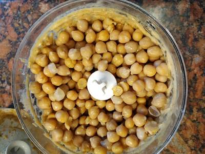 Gradually, add 1/4 of the chickpeas and process them for a minute and then add another 1/4 of the drained chickpeas and process for another minute Easy Hummus Recipe