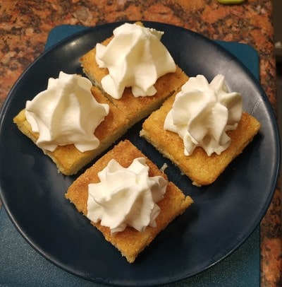 Cut the cake and put cream on top Lemon and Custard Cake