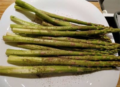 Toss the asparagus with the salt, pepper and extra virgin olive oil Roasted Asparagus with Grana Padana