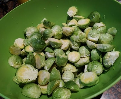 Halve and place the Brussels sprouts in a bowl Roasted Parmesan Brussels Sprouts