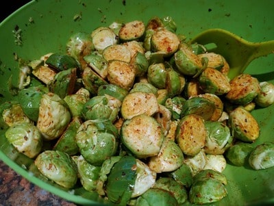Stir the Brussels sprouts to coat Roasted Parmesan Brussels Sprouts