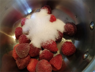 In a medium size sauce pan, add the strawberries with the sweetener Strawberry Puree